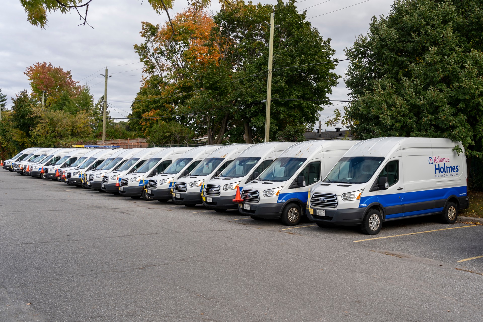 Many Reliance Holmes Heating’s vans in a parking lot in Ottawa, ON, Canada